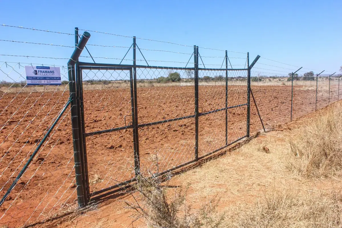 Long secure perimeter fence installed along a Zimbabwean property